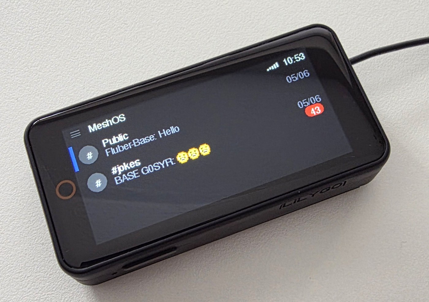 LilyGo T-Display S3 Pro running MeshOS, showing the public channel list